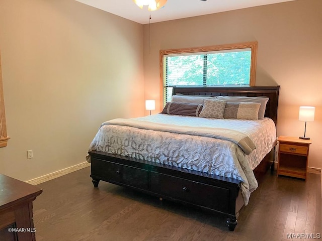 bedroom featuring baseboards and wood finished floors
