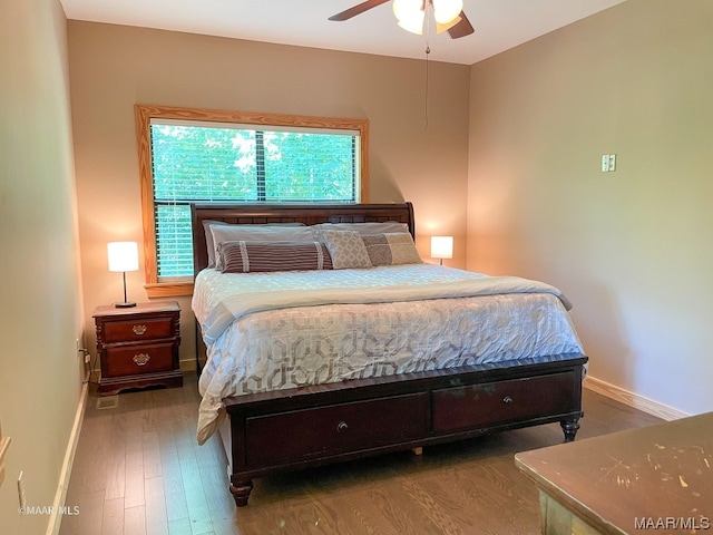 bedroom with ceiling fan and dark wood-type flooring