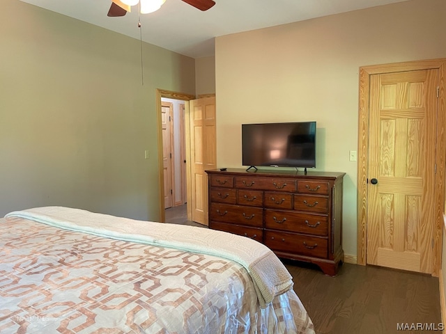 bedroom with ceiling fan and dark hardwood / wood-style flooring