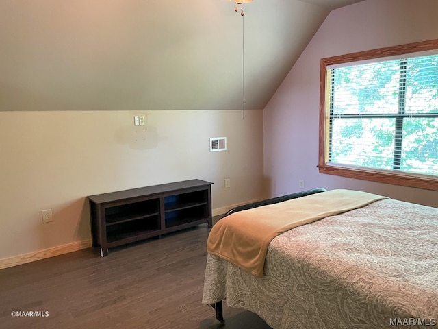 bedroom with lofted ceiling and dark hardwood / wood-style floors