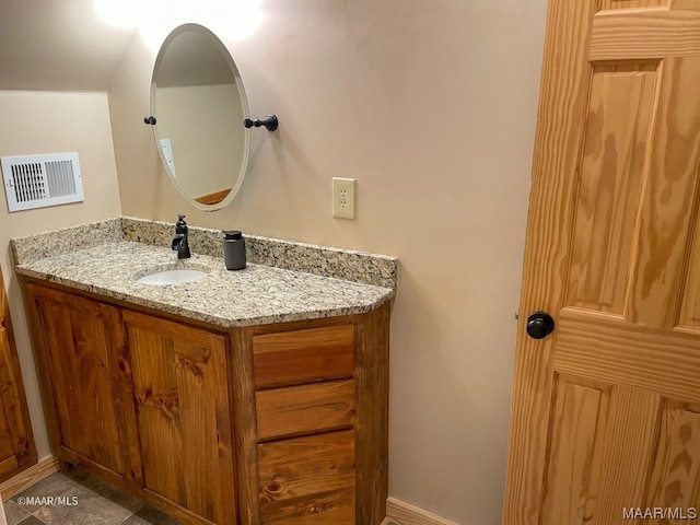 bathroom with tile floors and vanity