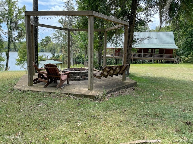 view of yard featuring a water view and an outdoor fire pit