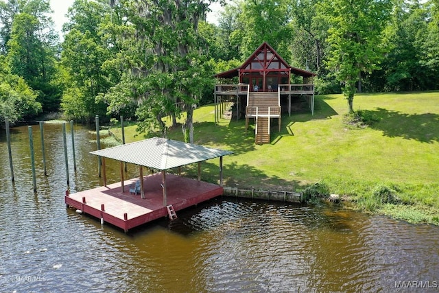 dock area with a yard, stairs, and a deck with water view