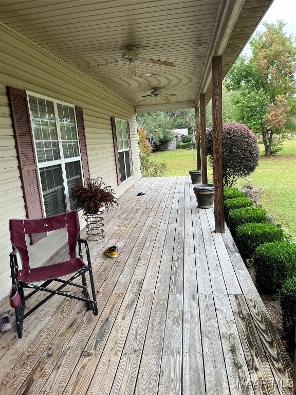 wooden terrace featuring ceiling fan and covered porch