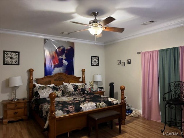 bedroom with hardwood / wood-style flooring, ceiling fan, and crown molding