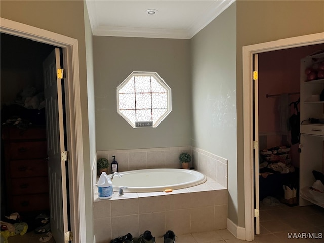 bathroom with tile patterned flooring, crown molding, and tiled tub