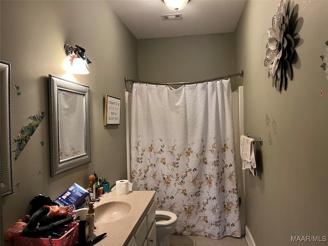 bathroom featuring tile patterned floors, vanity, and toilet