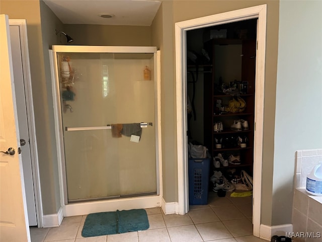 bathroom with tile patterned floors and walk in shower