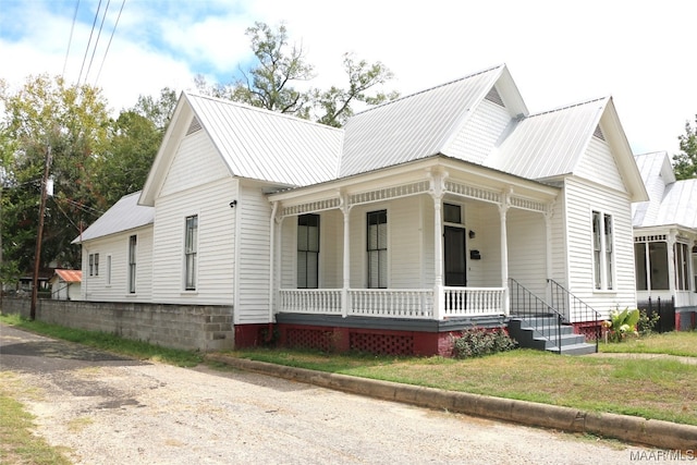 view of front facade with central AC and covered porch