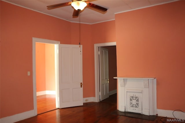 empty room featuring crown molding, dark hardwood / wood-style floors, and ceiling fan