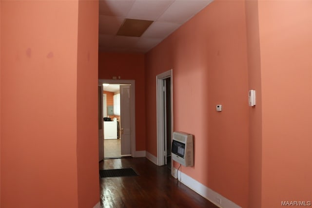 hallway with dark hardwood / wood-style floors and a drop ceiling