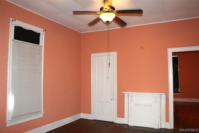 unfurnished room featuring ornamental molding, ceiling fan, and dark hardwood / wood-style flooring