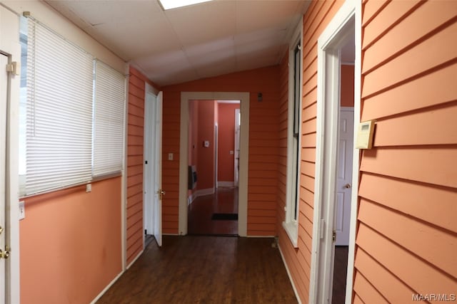 hallway with lofted ceiling and dark hardwood / wood-style flooring