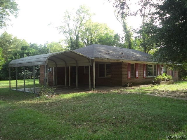 exterior space featuring a carport and a yard