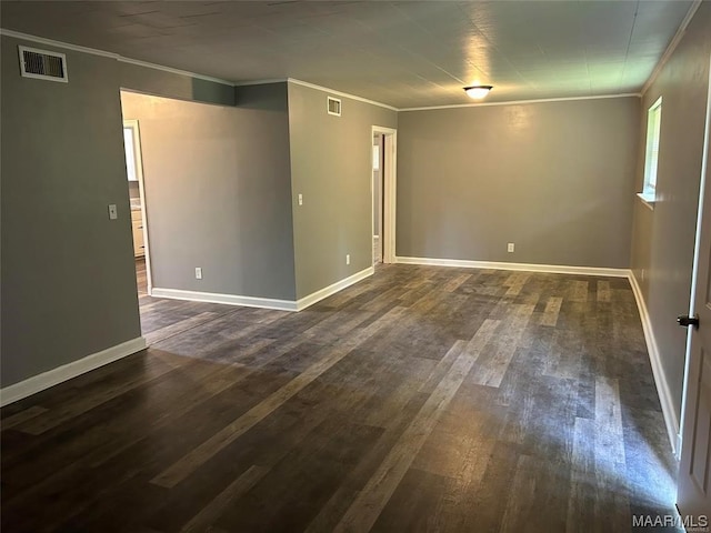 empty room with crown molding and dark hardwood / wood-style floors