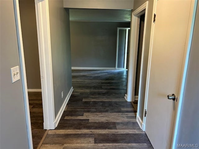 hallway with dark hardwood / wood-style floors