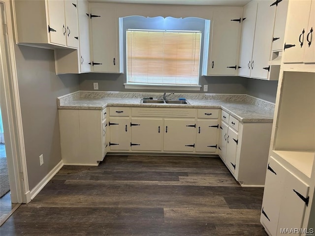 kitchen featuring white cabinets, dark hardwood / wood-style floors, and sink