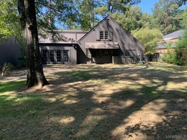 rear view of property with a yard