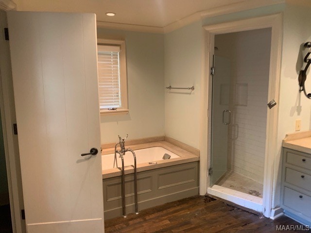 bathroom featuring vanity, separate shower and tub, and wood-type flooring