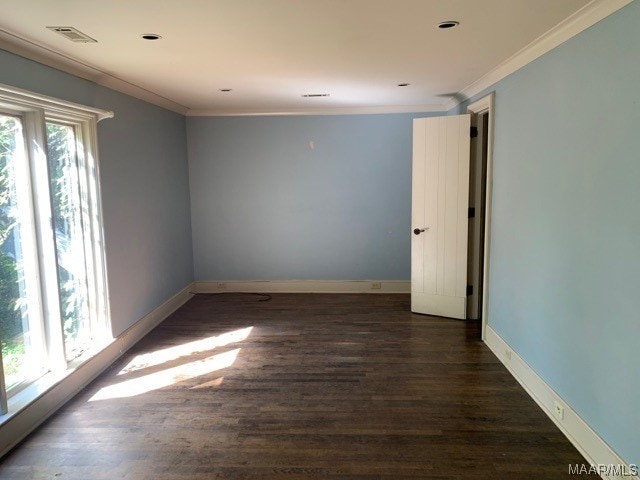 spare room with dark hardwood / wood-style flooring and ornamental molding