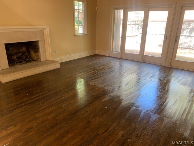 unfurnished living room with dark wood-type flooring