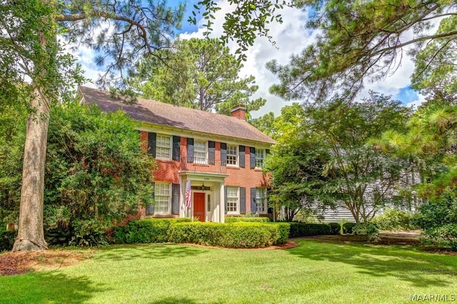 colonial-style house with a front yard