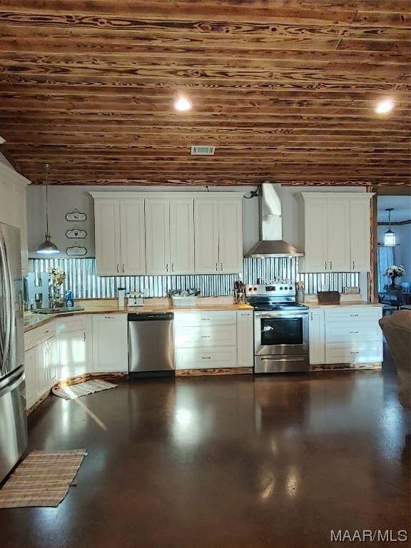115 County Road 489th Rd, Verbena, AL 36091 - kitchen with hanging light fixtures, white cabinetry, wall chimney range hood, and appliances with stainless steel finishes