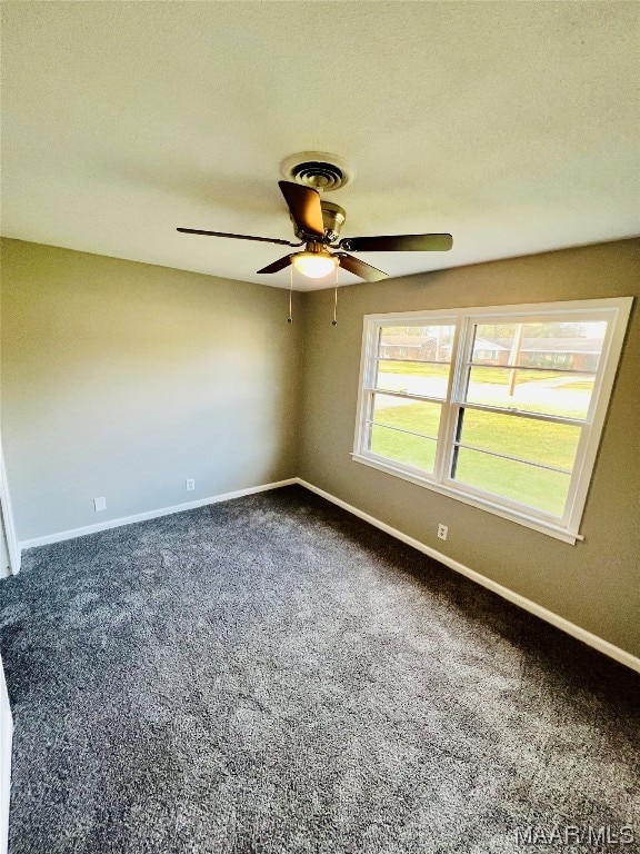 carpeted spare room with ceiling fan