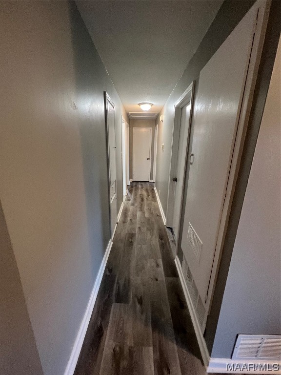 corridor with dark hardwood / wood-style floors