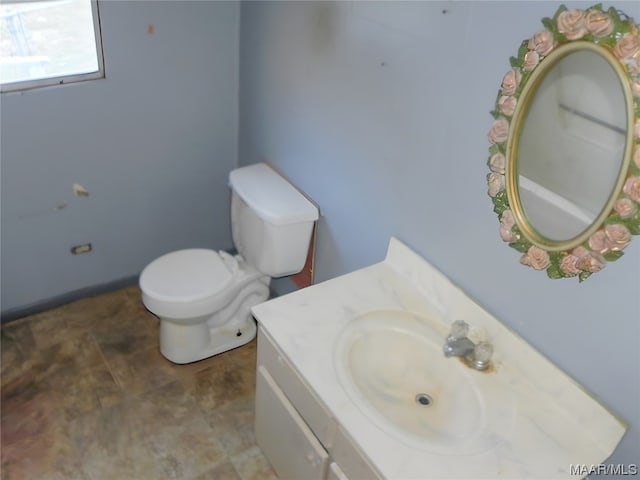 bathroom featuring toilet, tile floors, and vanity