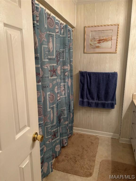 bathroom featuring wood walls and vanity