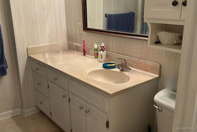 bathroom featuring tile patterned floors, vanity, and toilet