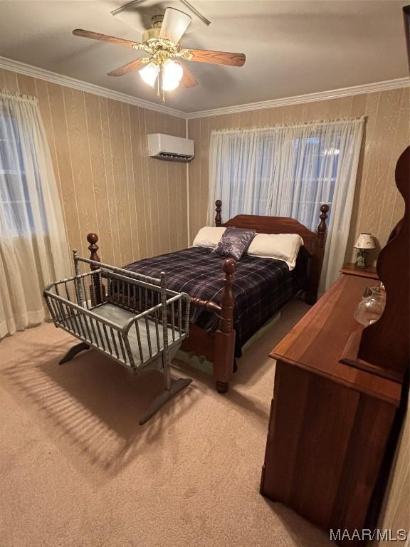 bedroom featuring light carpet, ornamental molding, an AC wall unit, and ceiling fan