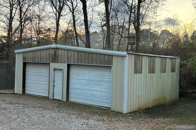 view of garage at dusk