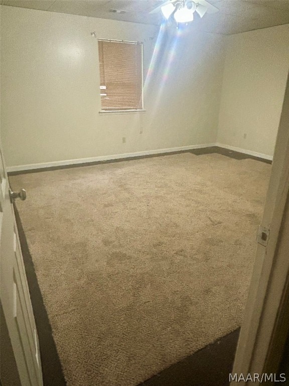 carpeted empty room with ceiling fan