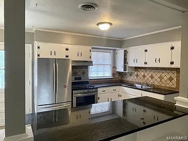 kitchen featuring white cabinetry, crown molding, decorative backsplash, and appliances with stainless steel finishes