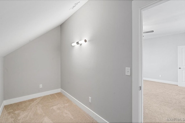 bonus room featuring lofted ceiling and light colored carpet