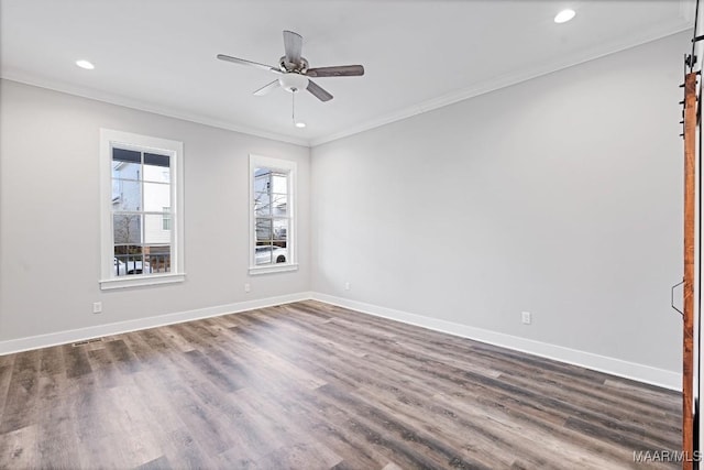 spare room with dark wood-type flooring, ornamental molding, and ceiling fan