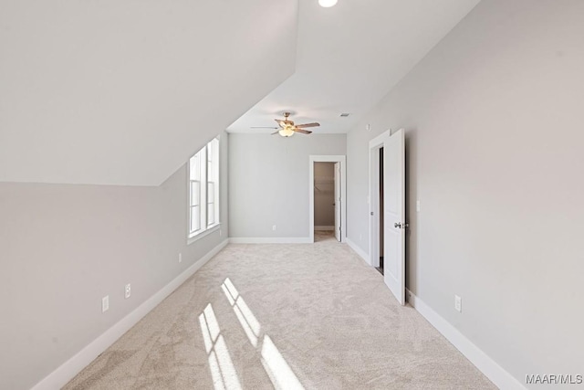 bonus room featuring ceiling fan, light colored carpet, and lofted ceiling