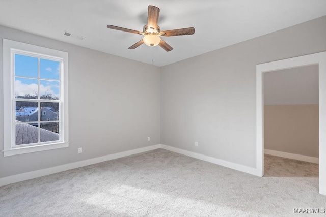 spare room with light carpet and ceiling fan