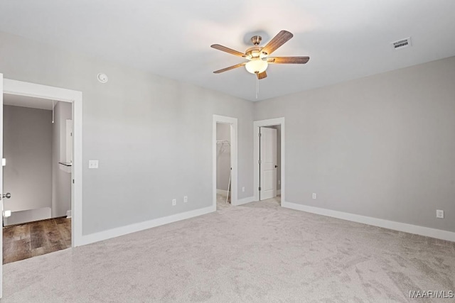 carpeted spare room with ceiling fan