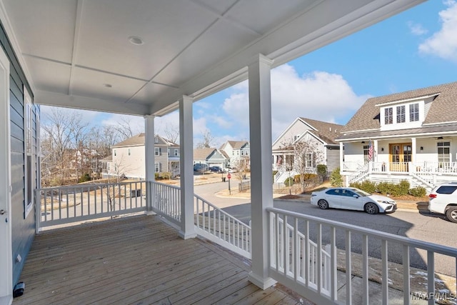 wooden terrace featuring covered porch