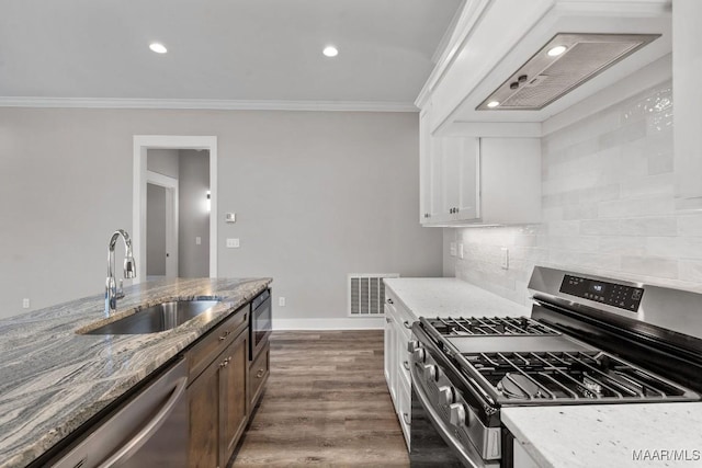 kitchen featuring white cabinetry, sink, backsplash, light stone counters, and stainless steel appliances