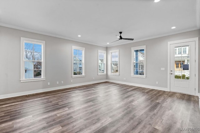 unfurnished living room featuring crown molding, dark wood-type flooring, and ceiling fan