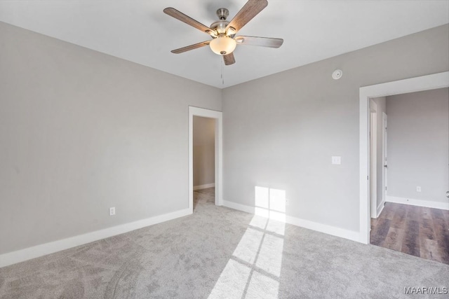 spare room featuring ceiling fan and light colored carpet