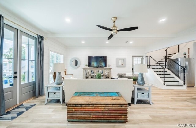 living room with ceiling fan, light wood-type flooring, and french doors