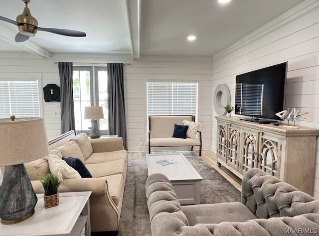 living room featuring wood walls, ceiling fan, dark hardwood / wood-style floors, and beamed ceiling