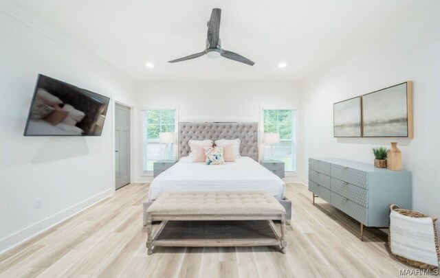 bedroom featuring ornamental molding, light hardwood / wood-style floors, and ceiling fan