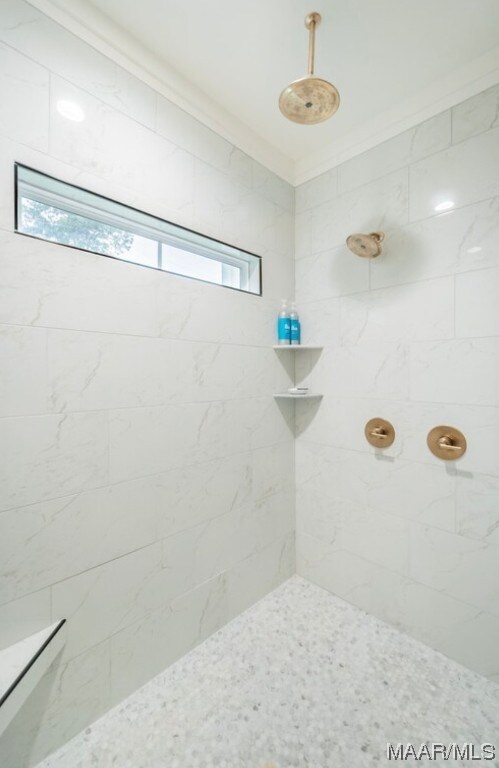 bathroom with tiled shower