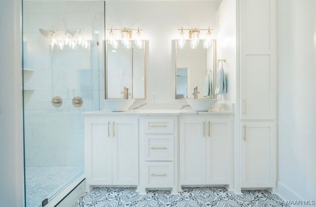 bathroom with dual sinks, tiled shower, tile floors, and vanity with extensive cabinet space